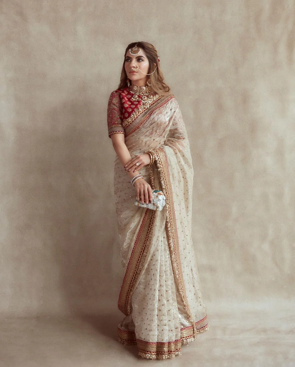 Regal Ivory Net Saree with Embroidered Red Blouse & Golden Lace Border